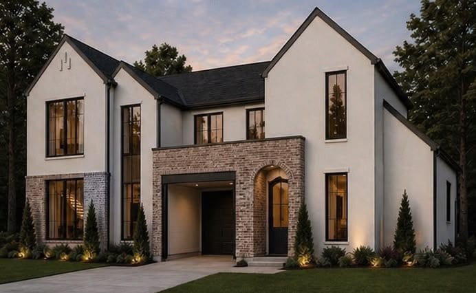 Custom residence at dusk with arched brick entry and attached garage, Dallas, Texas